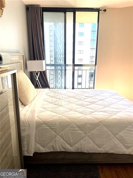 3481 Lakeside Unit 2204, Atlanta, GA 30326 - bedroom featuring wood finished floors, expansive windows, and access to exterior