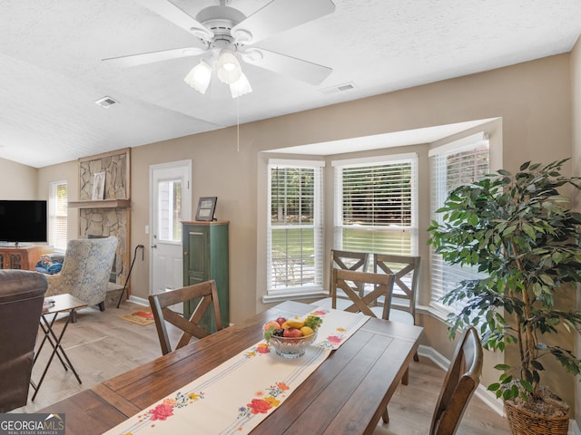2866 Rosecommons Dr, Hampton, GA 30228 - dining space with light wood-style flooring, plenty of natural light, ceiling fan, and a textured ceiling