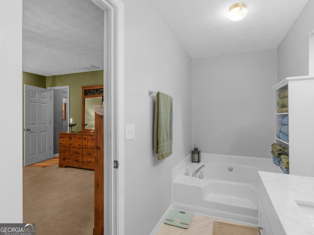 2866 Rosecommons Dr, Hampton, GA 30228 - bathroom featuring a textured ceiling, a bath, and vanity