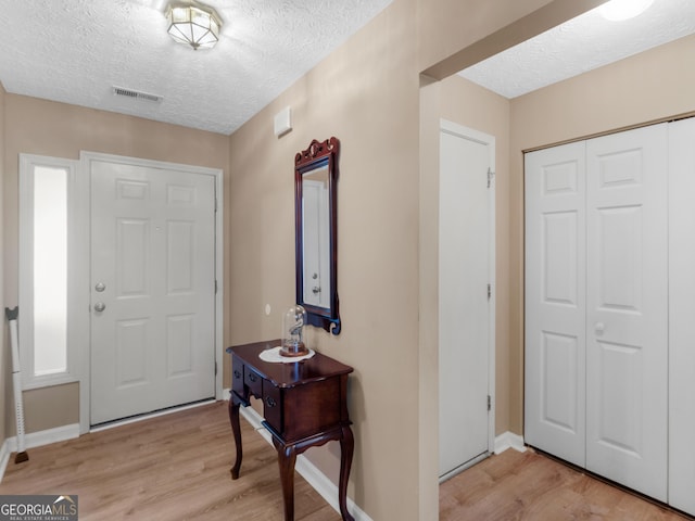 2866 Rosecommons Dr, Hampton, GA 30228 - entrance foyer with a textured ceiling and light wood-type flooring