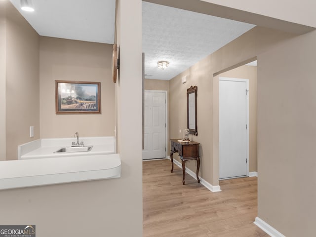2866 Rosecommons Dr, Hampton, GA 30228 - corridor with light wood-type flooring and a textured ceiling