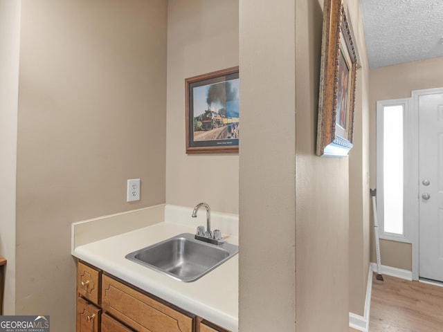 2866 Rosecommons Dr, Hampton, GA 30228 - bar with light wood finished floors and a textured ceiling