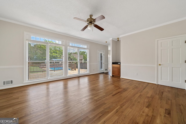 11 Chad Ct, Mcdonough, GA 30253 - unfurnished living room featuring crown molding, a ceiling fan, wood finished floors, and a textured ceiling