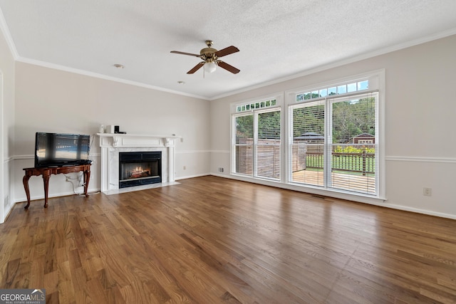 11 Chad Ct, Mcdonough, GA 30253 - unfurnished living room with a ceiling fan, wood finished floors, ornamental molding, a fireplace, and a textured ceiling
