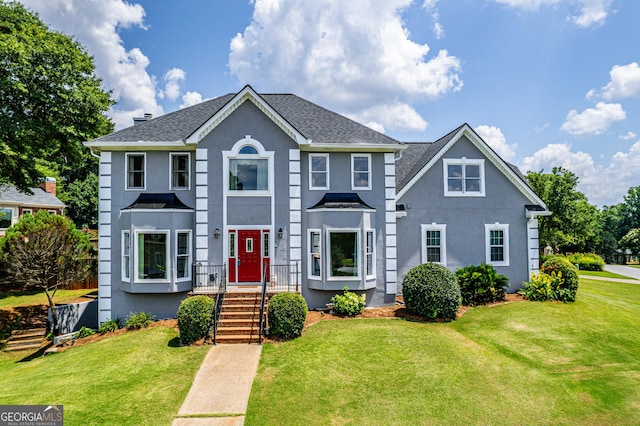 11 Chad Ct, Mcdonough, GA 30253 - colonial home with stucco siding, a front yard, and roof with shingles
