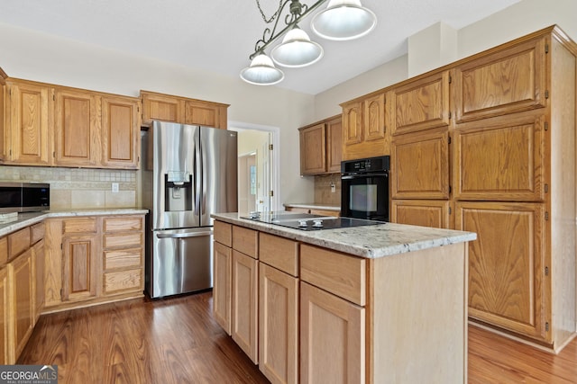 11 Chad Ct, Mcdonough, GA 30253 - kitchen featuring black appliances, dark wood-type flooring, tasteful backsplash, a center island, and light stone countertops