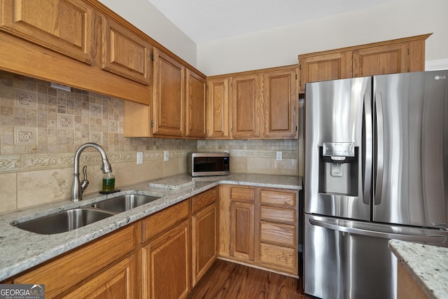 11 Chad Ct, Mcdonough, GA 30253 - kitchen with stainless steel appliances, brown cabinets, decorative backsplash, and light stone counters