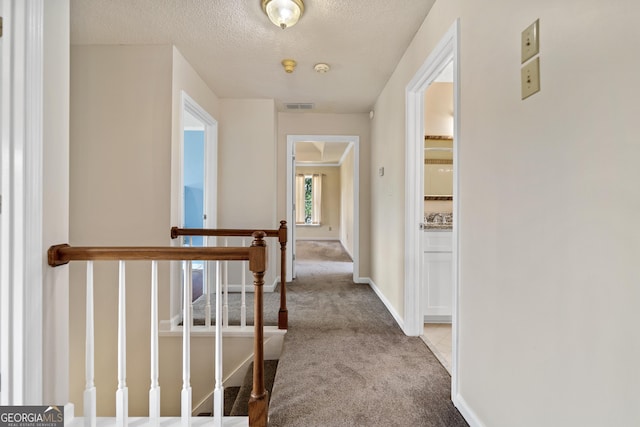 11 Chad Ct, Mcdonough, GA 30253 - hall featuring carpet floors, an upstairs landing, and a textured ceiling