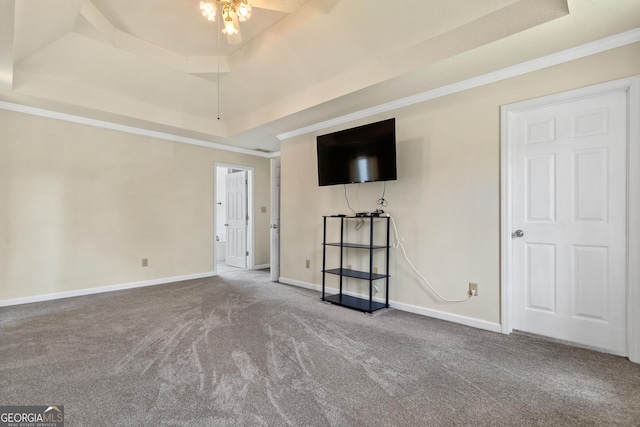 11 Chad Ct, Mcdonough, GA 30253 - unfurnished living room with a tray ceiling, carpet floors, ornamental molding, and a ceiling fan