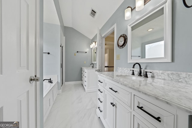 11 Chad Ct, Mcdonough, GA 30253 - bathroom with two vanities, a garden tub, marble finish floors, and vaulted ceiling
