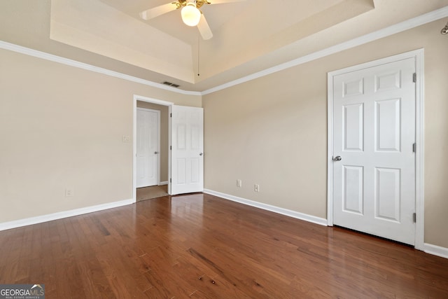 11 Chad Ct, Mcdonough, GA 30253 - empty room featuring a tray ceiling, a ceiling fan, ornamental molding, and wood finished floors