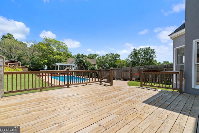 11 Chad Ct, Mcdonough, GA 30253 - deck with a fenced backyard, an outdoor structure, and view of scattered trees