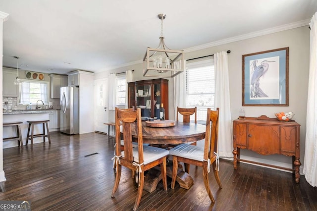963 Turner Dr SE, Smyrna, GA 30080 - dining space with dark wood-style flooring, a chandelier, and ornamental molding