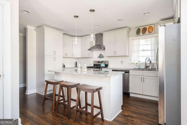 963 Turner Dr SE, Smyrna, GA 30080 - kitchen featuring wall chimney exhaust hood, appliances with stainless steel finishes, dark wood-style flooring, decorative backsplash, and recessed lighting