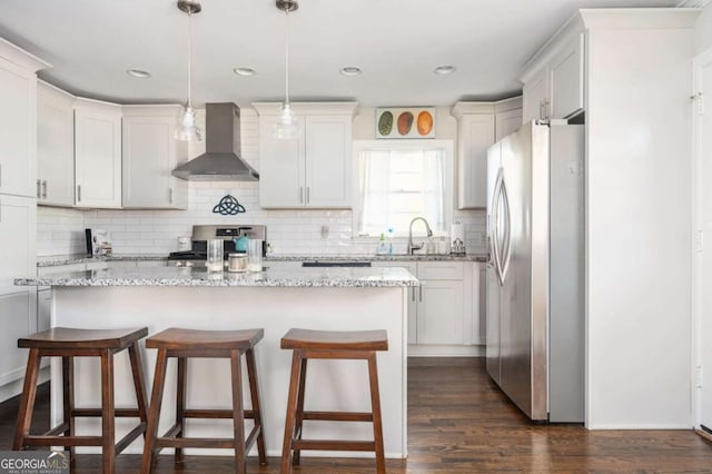 963 Turner Dr SE, Smyrna, GA 30080 - kitchen with wall chimney exhaust hood, freestanding refrigerator, range, a center island, and a breakfast bar area