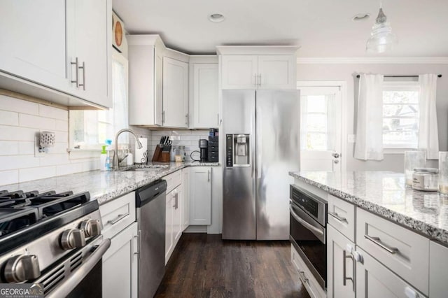 963 Turner Dr SE, Smyrna, GA 30080 - kitchen with stainless steel appliances, white cabinets, crown molding, dark wood-style floors, and tasteful backsplash