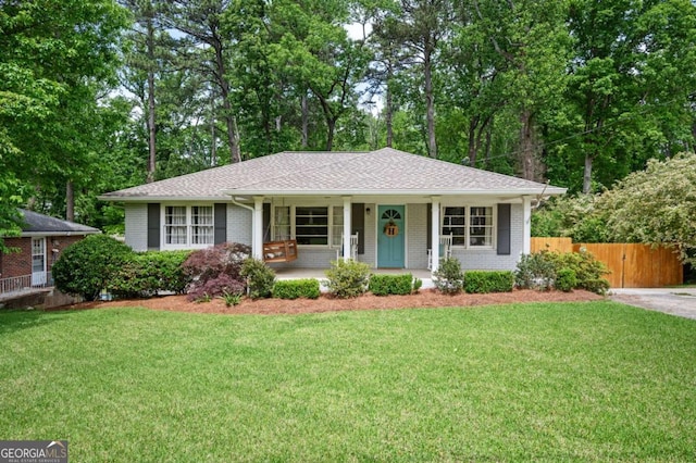 963 Turner Dr SE, Smyrna, GA 30080 - single story home featuring a porch, brick siding, and view of scattered trees