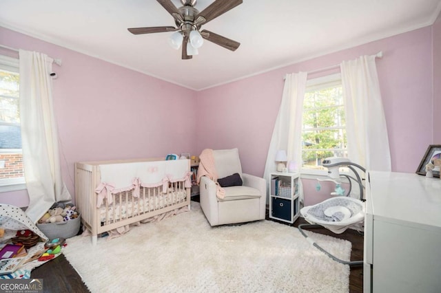 963 Turner Dr SE, Smyrna, GA 30080 - bedroom featuring a nursery area, a ceiling fan, and ornamental molding