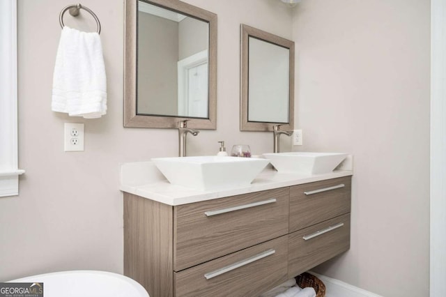 963 Turner Dr SE, Smyrna, GA 30080 - bathroom featuring double vanity and a freestanding tub