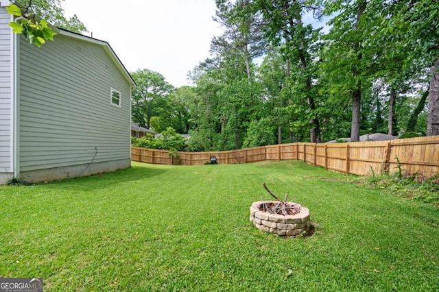 963 Turner Dr SE, Smyrna, GA 30080 - fenced backyard featuring an outdoor fire pit