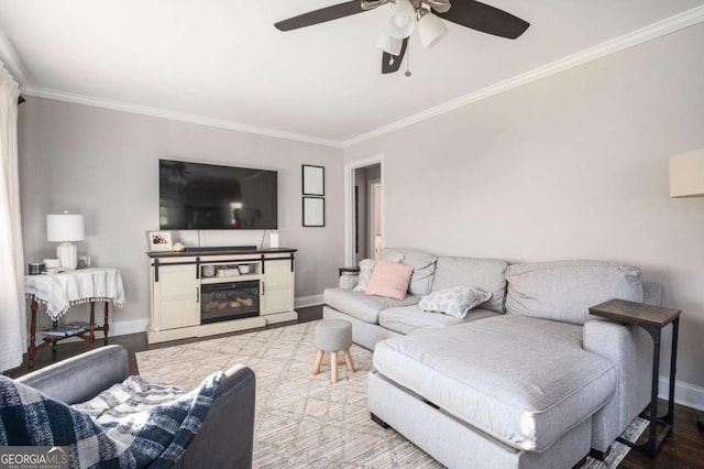 963 Turner Dr SE, Smyrna, GA 30080 - living area featuring crown molding, a ceiling fan, wood finished floors, and a glass covered fireplace