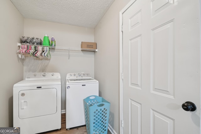 600 Cowan Rd, Covington, GA 30016 - washroom with washer and clothes dryer, wood finished floors, and a textured ceiling