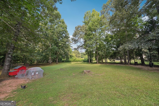 600 Cowan Rd, Covington, GA 30016 - view of grassy yard featuring an outdoor structure and view of wooded area