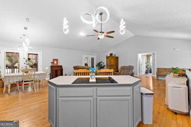 152 Bear Creek Rd, Moreland, GA 30259 - kitchen featuring a kitchen island, ceiling fan, black electric stovetop, light wood-type flooring, and lofted ceiling