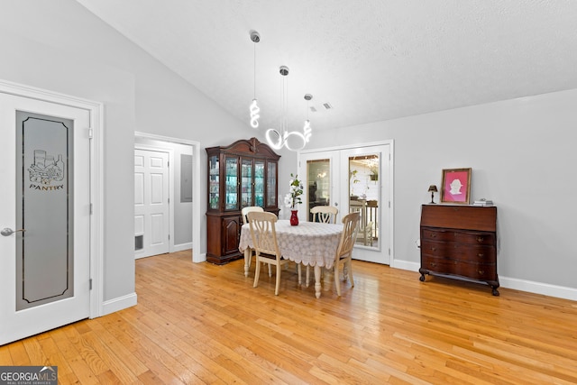 152 Bear Creek Rd, Moreland, GA 30259 - dining space with a chandelier, light wood-style floors, and vaulted ceiling