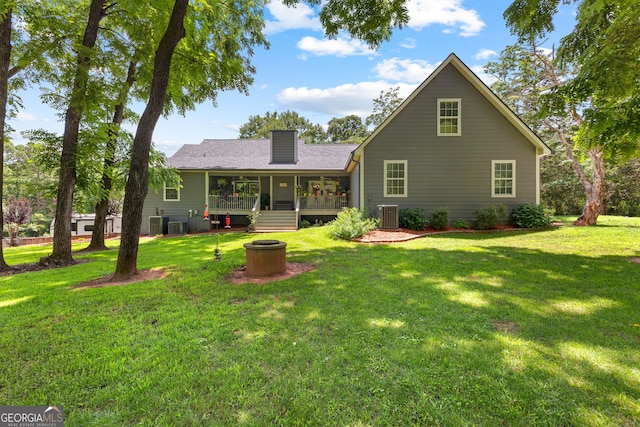 152 Bear Creek Rd, Moreland, GA 30259 - rear view of property featuring a fire pit, a lawn, a chimney, and a wooden deck