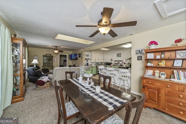 303 Cherokee St, Pine Mountain, GA 31822 - dining area featuring a ceiling fan, light colored carpet, a skylight, and a textured ceiling