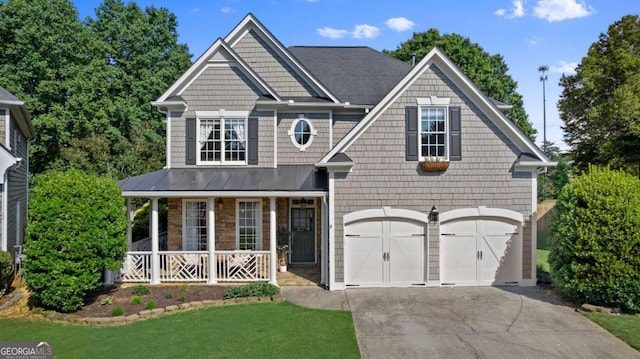 220 Brookeivey Ln, Milton, GA 30004 - view of front of home with a porch, driveway, a garage, a front yard, and a standing seam roof