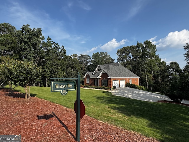 131 Winesap Way, Clarkesville, GA 30523 - view of front of house featuring a front lawn, an attached garage, brick siding, and driveway