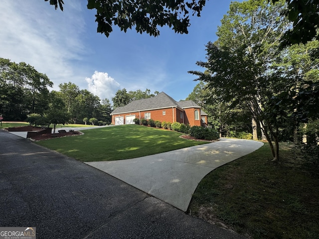 131 Winesap Way, Clarkesville, GA 30523 - view of home's exterior featuring a lawn, concrete driveway, a garage, and brick siding