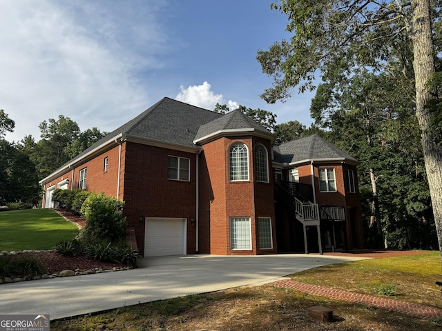 131 Winesap Way, Clarkesville, GA 30523 - view of front of home featuring brick siding, driveway, an attached garage, a front yard, and a shingled roof