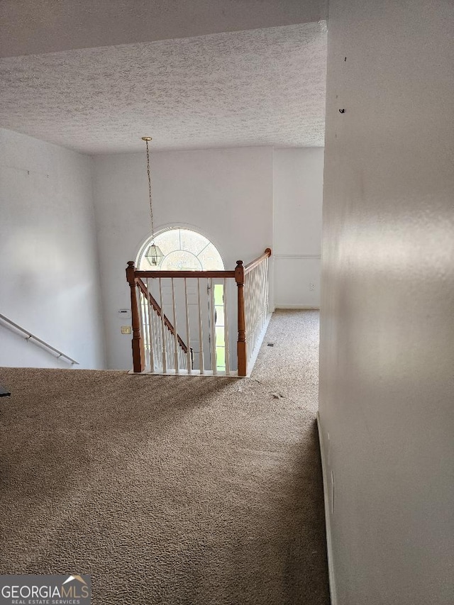 3059 Brass Dr, Austell, GA 30106 - hall featuring carpet flooring, a textured ceiling, and an upstairs landing