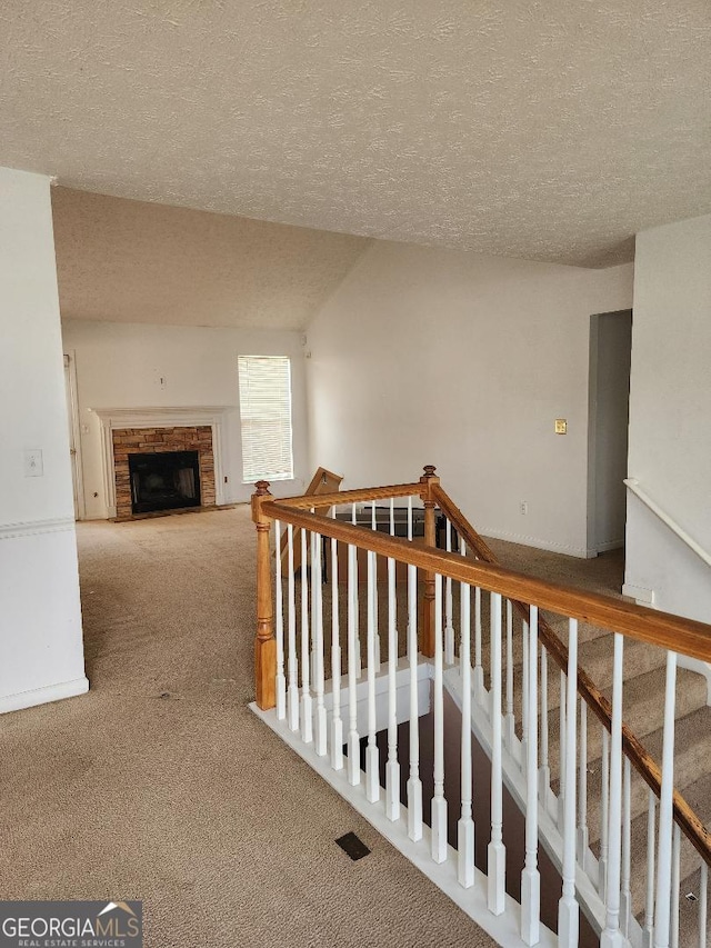3059 Brass Dr, Austell, GA 30106 - hallway featuring carpet floors, a textured ceiling, and an upstairs landing