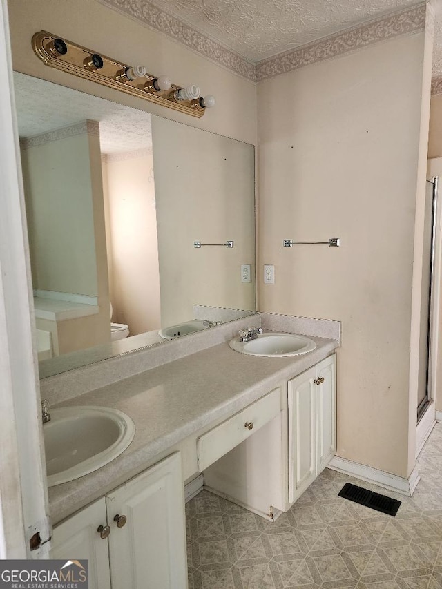 3059 Brass Dr, Austell, GA 30106 - full bathroom featuring double vanity, tile patterned floors, a shower stall, and a textured ceiling