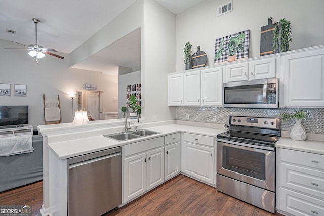 231 Brookstone Ct, Rincon, GA 31326 - kitchen with appliances with stainless steel finishes, open floor plan, tasteful backsplash, and a peninsula