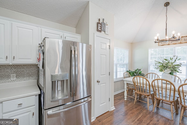 231 Brookstone Ct, Rincon, GA 31326 - kitchen with stainless steel fridge, lofted ceiling, a chandelier, wood finished floors, and white cabinetry