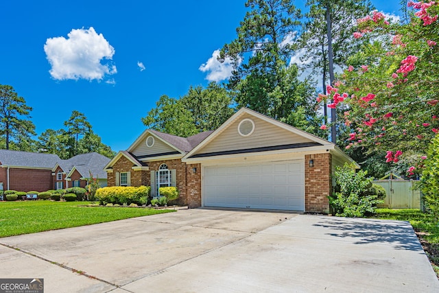 231 Brookstone Ct, Rincon, GA 31326 - view of front of house with brick siding, driveway, a garage, and a front yard