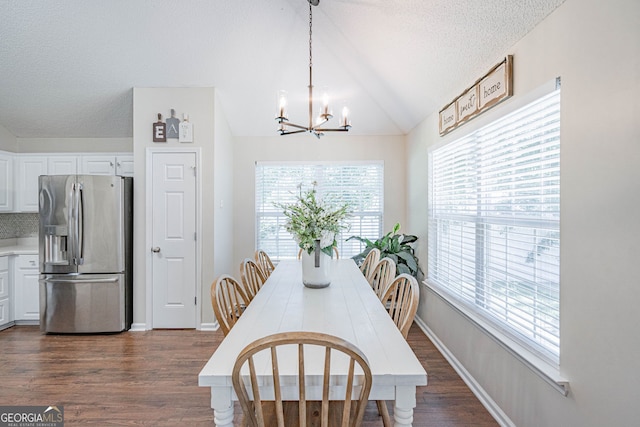 231 Brookstone Ct, Rincon, GA 31326 - dining space with a chandelier, dark wood finished floors, plenty of natural light, a textured ceiling, and lofted ceiling