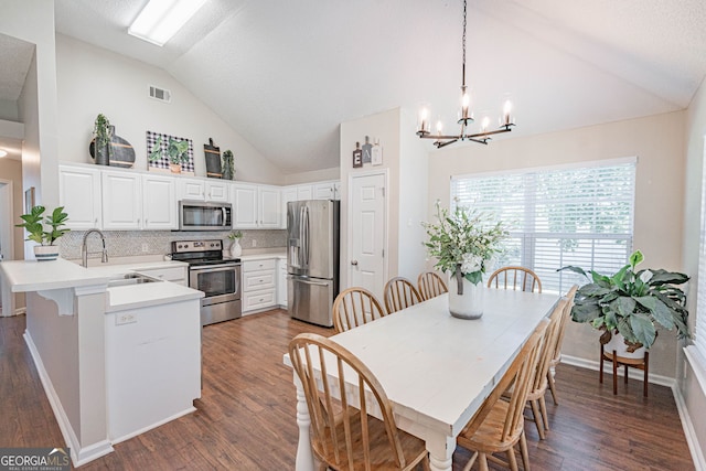231 Brookstone Ct, Rincon, GA 31326 - dining room with a chandelier, high vaulted ceiling, and dark wood-style floors