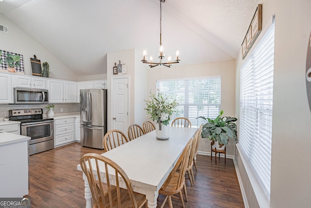 231 Brookstone Ct, Rincon, GA 31326 - dining area with a chandelier, dark wood finished floors, a textured ceiling, and high vaulted ceiling