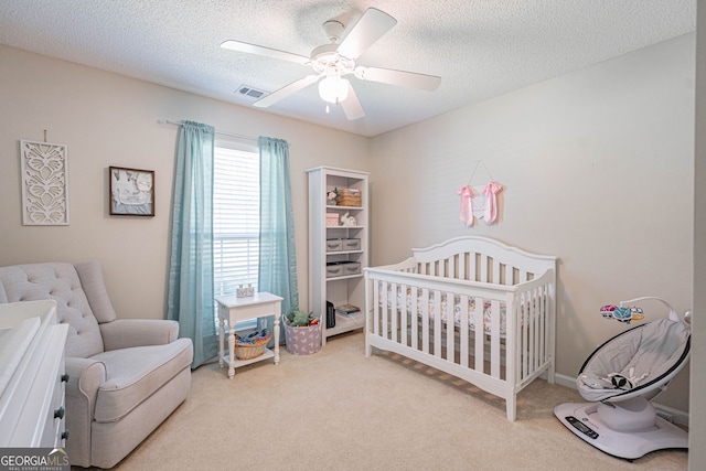 231 Brookstone Ct, Rincon, GA 31326 - bedroom featuring carpet floors, a crib, a ceiling fan, and a textured ceiling