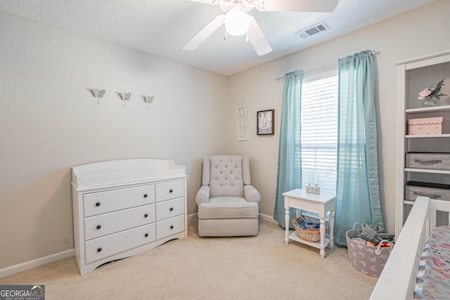 231 Brookstone Ct, Rincon, GA 31326 - bedroom with carpet floors, a ceiling fan, a crib, and a textured ceiling