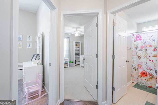 231 Brookstone Ct, Rincon, GA 31326 - bathroom featuring a textured ceiling, a ceiling fan, and curtained shower