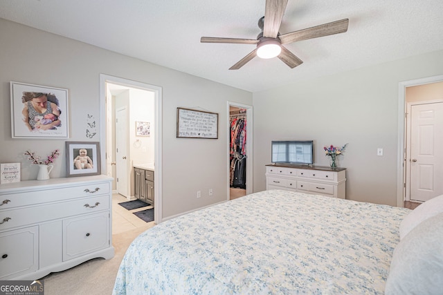 231 Brookstone Ct, Rincon, GA 31326 - bedroom with a walk in closet, a closet, light colored carpet, connected bathroom, and ceiling fan