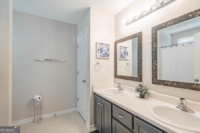 231 Brookstone Ct, Rincon, GA 31326 - bathroom with double vanity, tile patterned floors, and a textured ceiling