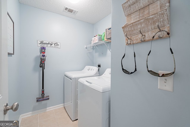 231 Brookstone Ct, Rincon, GA 31326 - washroom with washer and clothes dryer, a textured ceiling, and light tile patterned floors